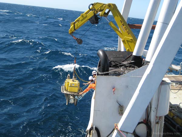 Lowering the sonar towfish into the water.